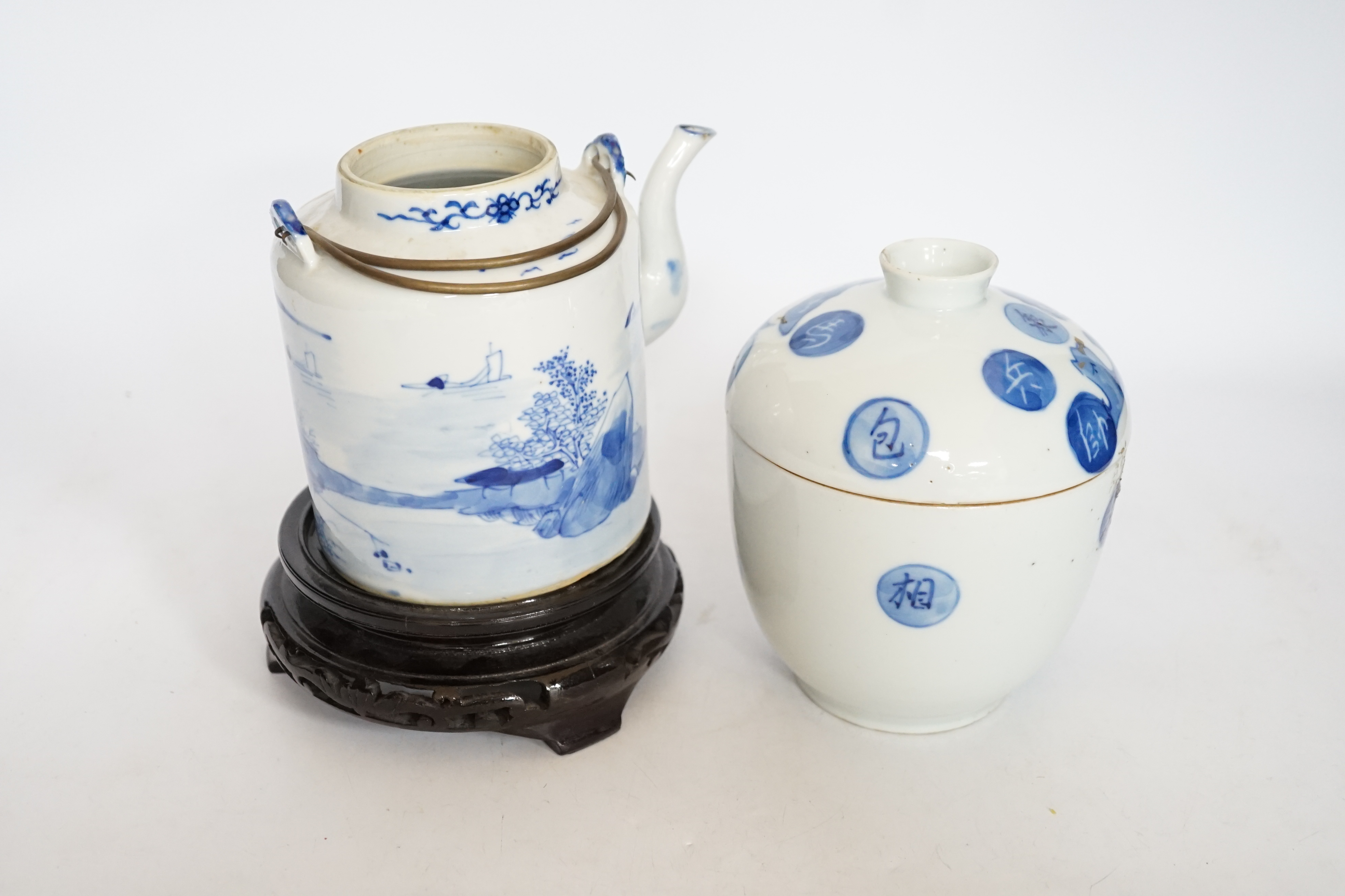 A Chinese Straits blue and white jar and cover, 19th century, a cylindrical teapot and an associated hardwood stand, largest 15cm high